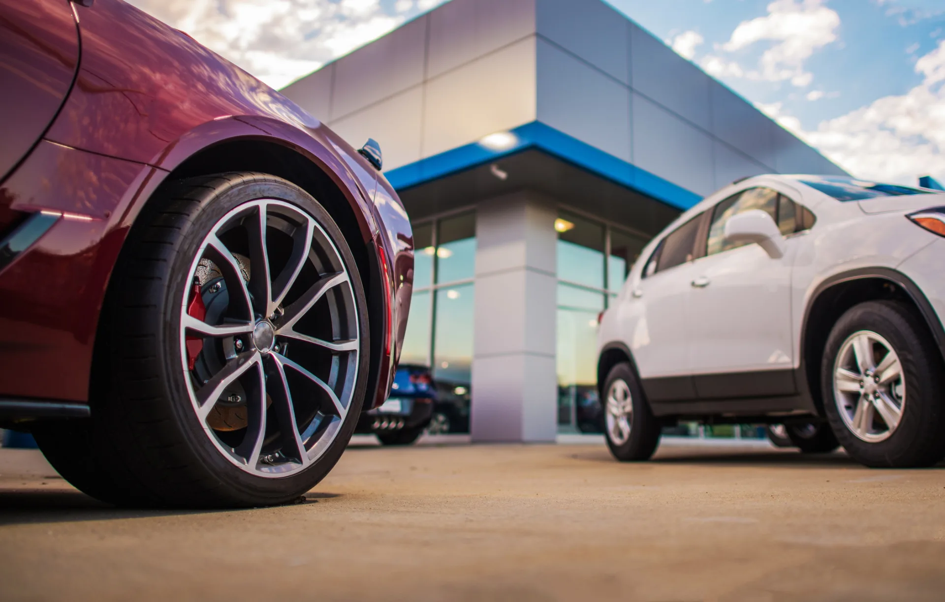 A car dealership lot featuring two cars for sale